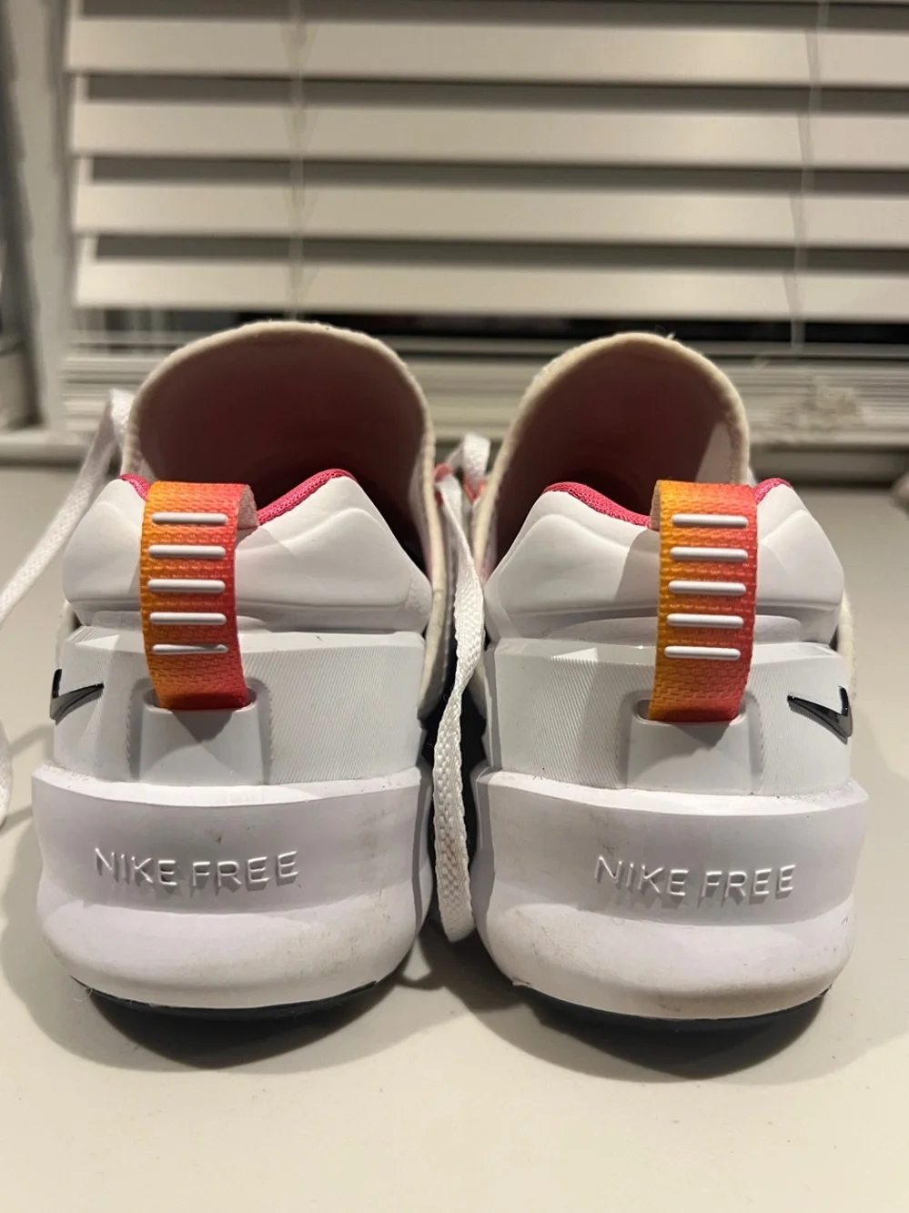 Nike White Metcon Training Shoes with Black Swoosh and Pink/Orange Pull Tabs